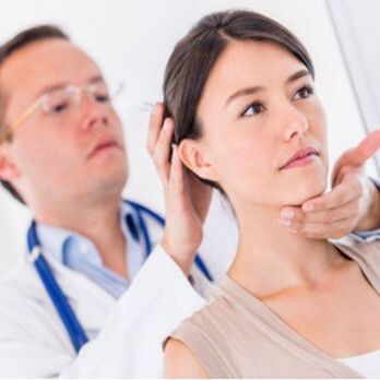 A neurologist examines a patient with neck pain
